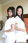 Filipino Caregivers Joanna and Joy Pose in Bed in Their White Uniforms 
Hot Filipino Nurses Joanna and Joy in White Uniforms on Bed