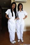 Filipino Caregivers Joanna and Joy Pose in Bed in Their White Uniforms 
Hot Filipino Nurses Joanna and Joy in White Uniforms on Bed