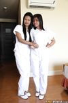 Filipino Caregivers Joanna and Joy Pose in Bed in Their White Uniforms 
Hot Filipino Nurses Joanna and Joy in White Uniforms on Bed