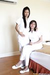 Filipino Caregivers Joanna and Joy Pose in Bed in Their White Uniforms 
Hot Filipino Nurses Joanna and Joy in White Uniforms on Bed