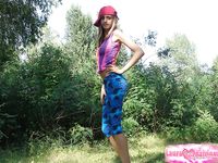 Naked teen debuts solo by pine trees in pulled-down beanie.