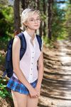 Young girl Azshara strips off her school uniform on a dirt road in the forest. 
Forest Stripper: Schoolgirl Azshara's Naughty Roadside Show