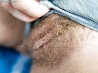 Fresh-faced blonde Aisling strips outdoors and spreads her hairy pussy.