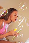 Danica blows bubbles while showing off her tits solo.
