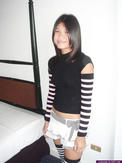 Young Asian Girl Drinks Beer While Stripping to Put on Lingerie and Thigh-High Stockings
Seductive Asian Babe Sips Beer, Strips, and Slips into Lingerie & Stockings