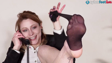 Seductive secretary shows off her feet in black thigh highs