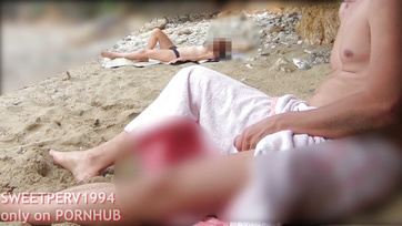 A petite girl jerks off a kinky guy at the beach