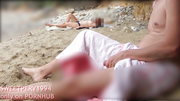 A petite girl jerks off a kinky guy at the beach