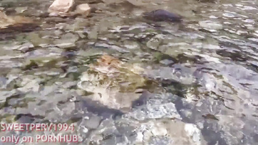 A petite girl jerks off a kinky guy at the beach