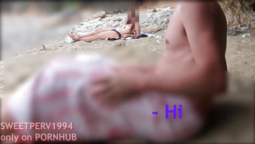 A petite girl jerks off a kinky guy at the beach
