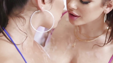 Big-titted girls sharing a dildo while licking each other's pussies
